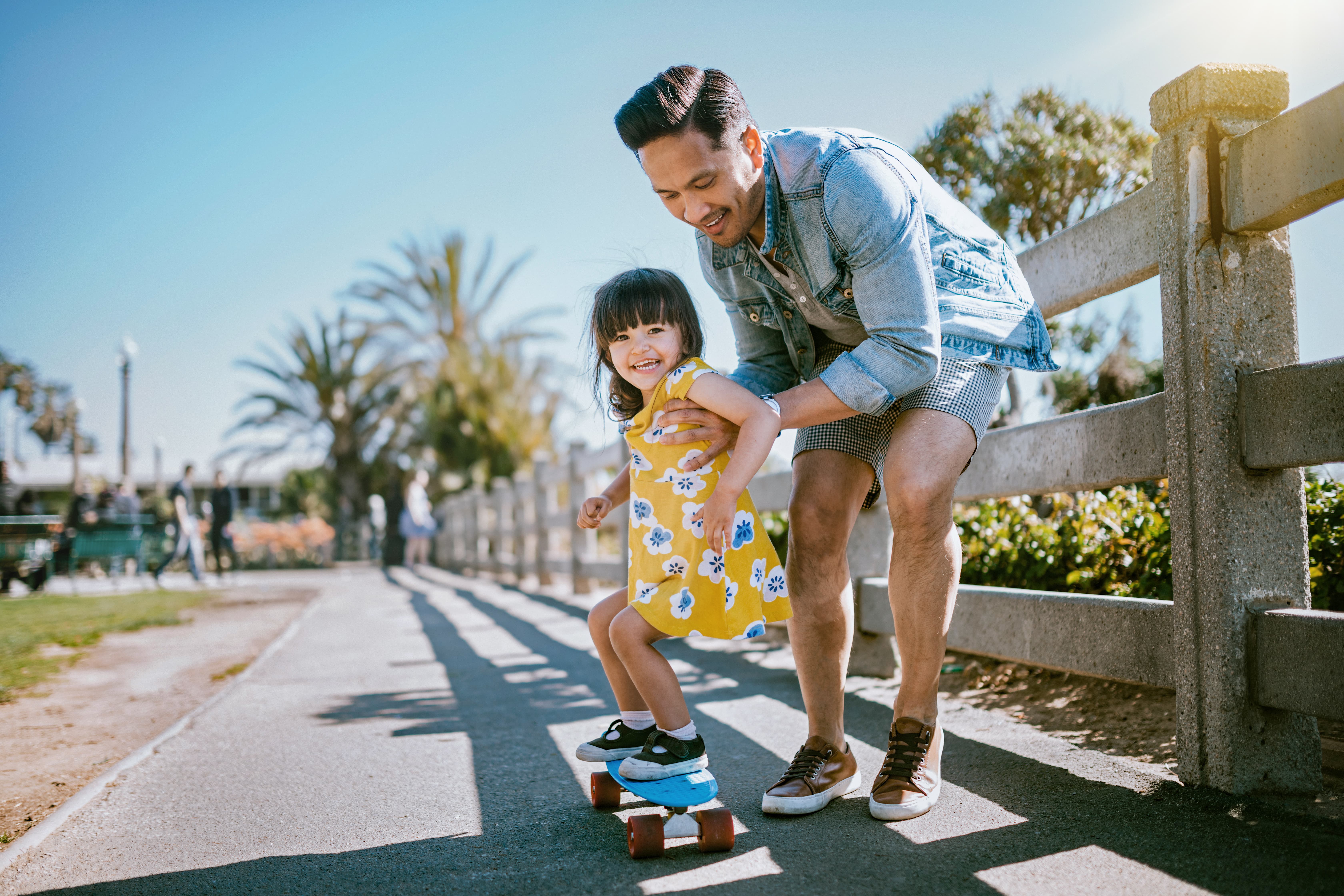 Father and daughter skateboarding.